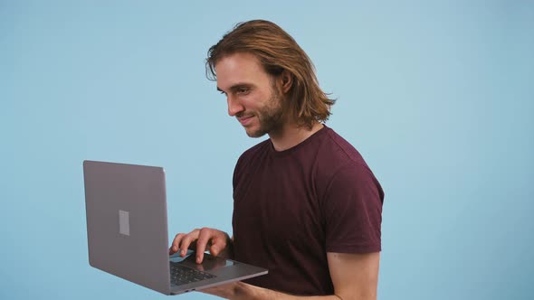 Male Holding Laptop Using and Closing It Rejoicing About Success Screaming Yes and Smiling Posing on