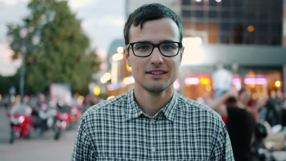 Happy Guy in Glasses Smiling Standing in Pedestrian Street in Modern City