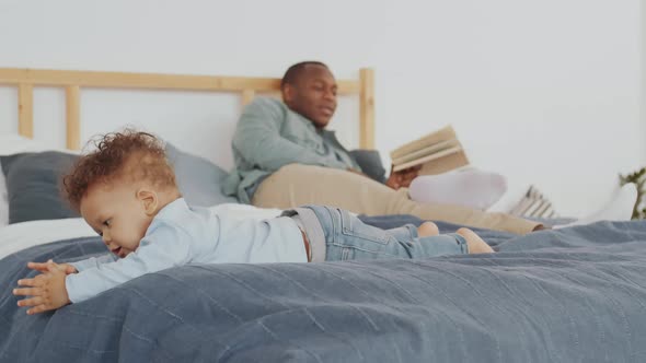 Man Reading Book to Toddler