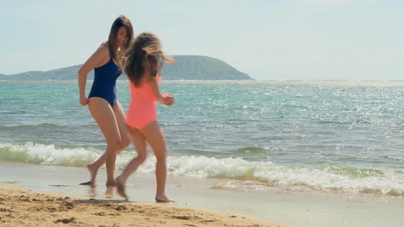 Mother and Daughter Having Fun at The Beach 4k