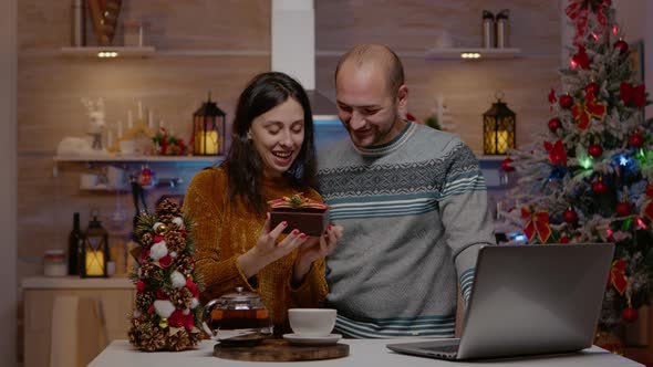 Cheerful Couple Receiving Presents on Video Call for Christmas