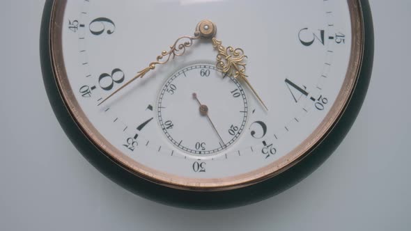 Antique Pocket Watch with a White Dial and Gold Moving Second Minute and Hour Hands on a Light Gray