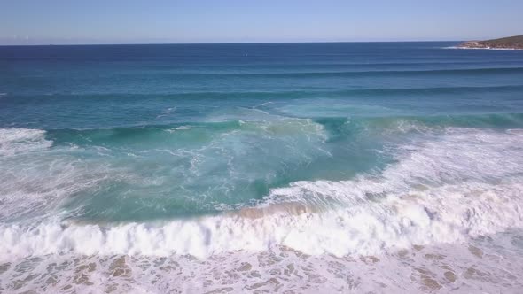 Aerial view of waves crashing the shore