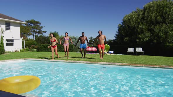 Diverse group of friends having jumping into a swimming pool