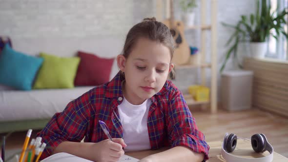 Close Up Teenager Uses a Laptop To Do Homework