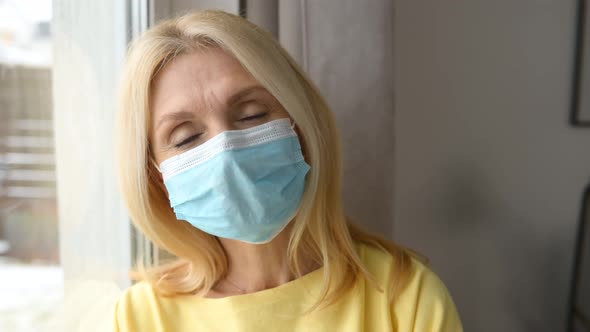 Portrait of Mature Caucasian Female Office Worker Wearing Face Mask Looking at Camera