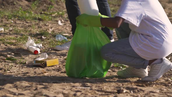 HANDHELD Ecoactivists Clean Up Garbage in the Forest Fight Against Plastic Pollution of Nature