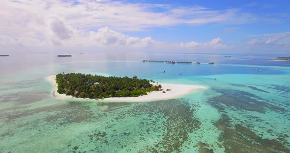 Aerial drone view of a scenic tropical island in the Maldives.