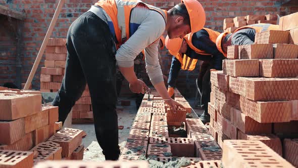 Builders Building a Brick Wall