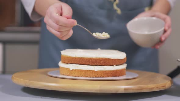 The Pastry Chef Adds White Chocolate Balls to the Cream of the Cake