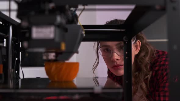 Female Student in a Modern Classroom Observing the Printing Process of a 3d Model