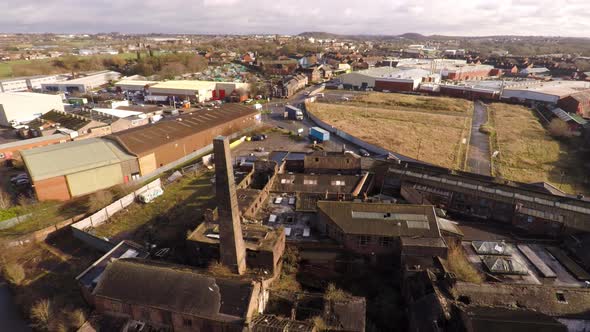 Aerial footage of an old abandoned, derelict pottery factory and bottle kiln located in Longport, St