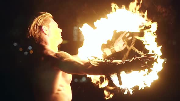 Young Blond Male Spins Two Burning Pois Tied Together Slow Motion Shot Closeup