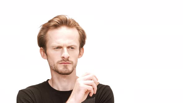 Young Handsome Man Thinking Holding Cigarette Over White Background