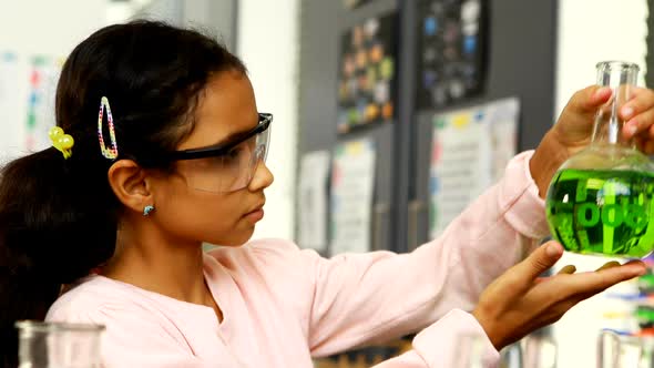 Schoolkid examining chemical in laboratory 4k