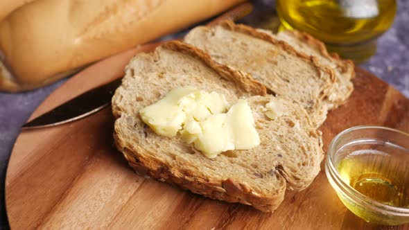 Butter and Whole Grain Bread on Table