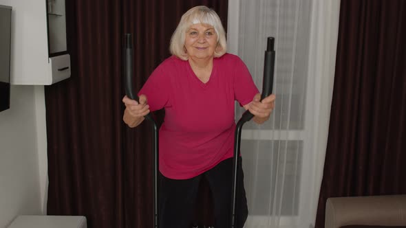Senior Woman in Sportswear Using Orbitrek in Room at Home Doing Sport Training Cardio Exercises