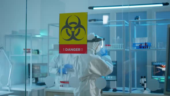 Scientist Team in Protective Suit Preparing Tools for Analysing Virus Development