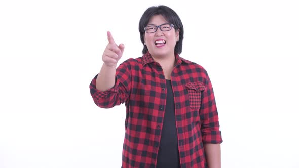 Happy Overweight Asian Hipster Woman Pointing Finger