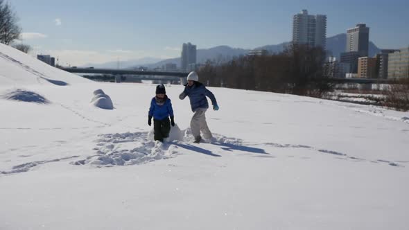 Cute Asian Children Playing On Snow In The Park Together,Sapporo Hokkaido Japan Slow Motion 