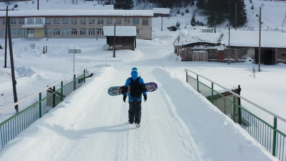 Aerial View of a Snowboard Crossing the Bridge in Winter