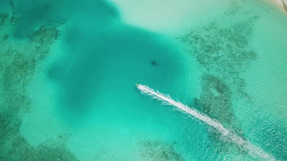 Aerial View of Jet Ski Racing on a Crystal Clear Turquoise Water in Maldives