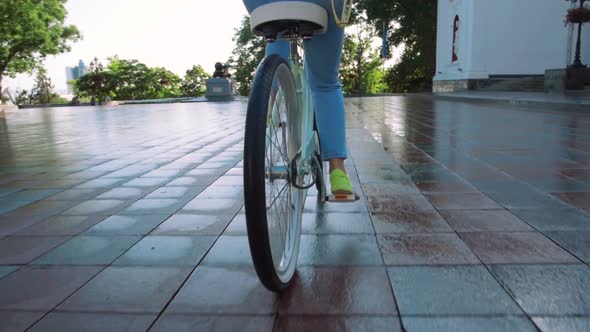 Young Attractive Woman in Hat Riding on Vintage Bike in City Center and Having Some Fun