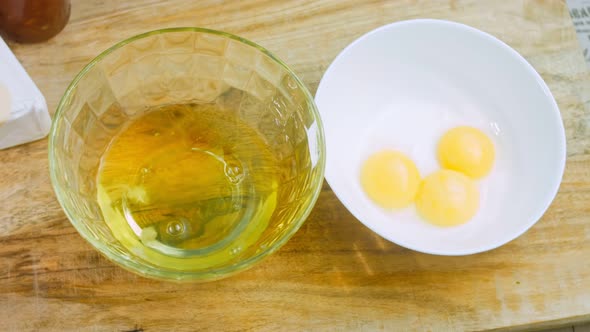 Three Egg Yolks in One Bowl and the Egg White in Another Bowl