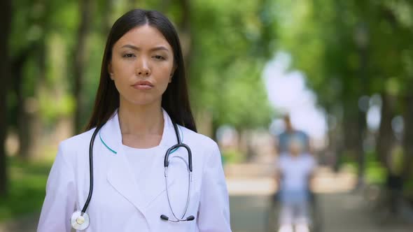 Serious Female Doctor Looking Into Camera at Rehabilitation Center Park, Health