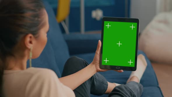 Caucasian Female Lying on Sofa Having Online Meeting on Tablet Computer