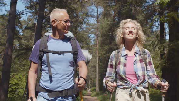 Happy Active Seniors Enjoying Trekking Trip in Forest