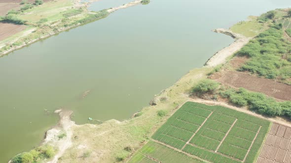 Stunning Nature Scenery Of River And Green Fields At The Rural Area In Maharashtra, India - aerial d