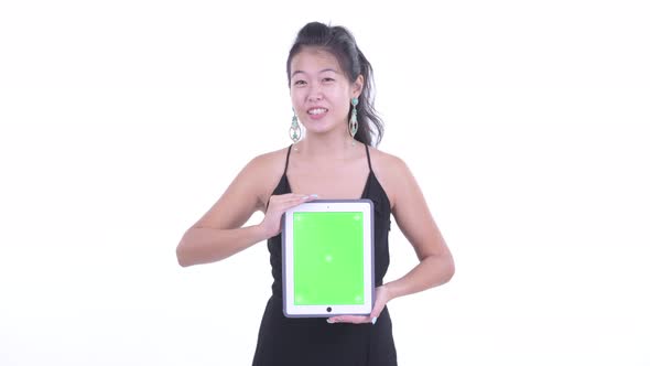 Happy Beautiful Asian Woman Talking While Showing Digital Tablet