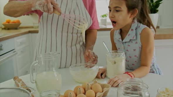 Grandmother and Child Cook Dough Together