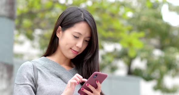 Woman work on mobile phone at outdoor