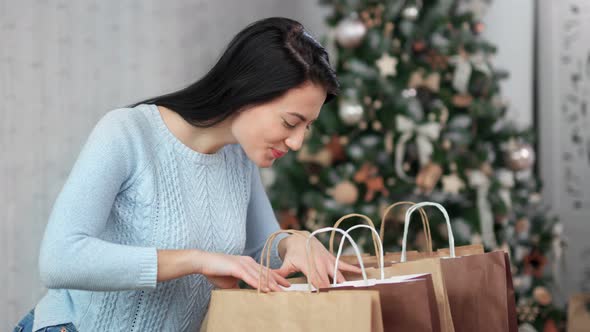Satisfied Beautiful Asian Young Woman Open Shopping Bag with Xmas Gift
