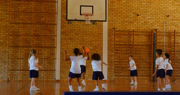 Schoolkids practicing basketball in basketball court at school 4k
