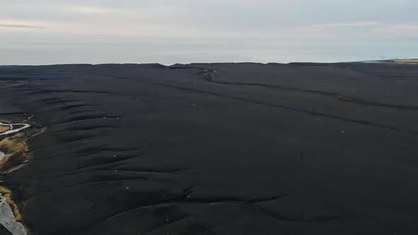 Drone Over Black Sand Towards Horizon