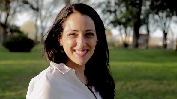 Attractive Female Smile to Camera Outdoors During Sunset