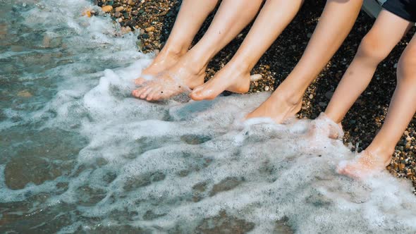 Summer Holiday. The Sea. Feet Splashing in the Surf