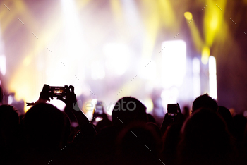 Arms Holding Smart Phones to Recording a Live Concert