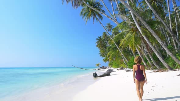 Slow motion: adult mature woman walking on tropical beach turquoise water caribbean sea alt