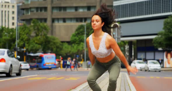 Young female dancer dancing on the street in the city 4k