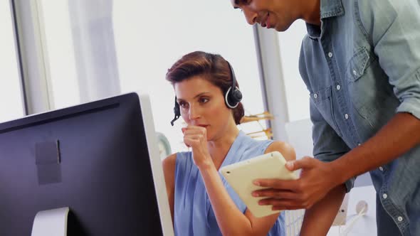 Executives interacting while working on computer and digital tablet 4k