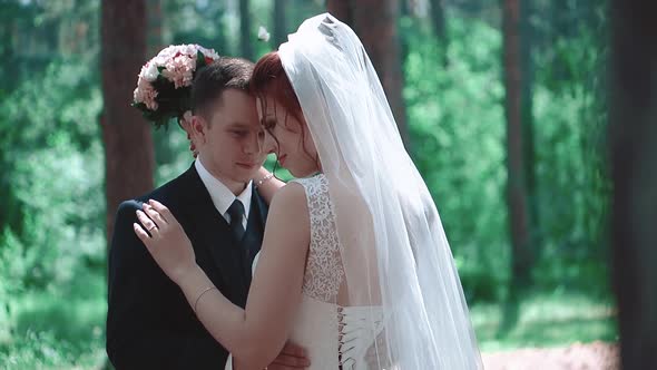 Newlyweds Hugging Standing in the Woods Closeup