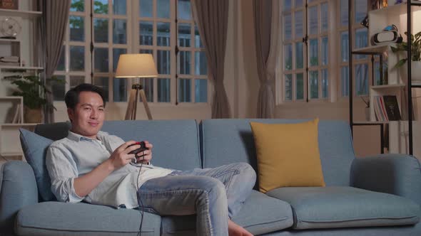 Handsome Man Gamer Siting On Sofa Playing A Game At Home, Relax Time