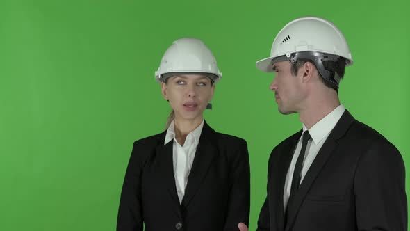 Female Construction Engineer Pointing Up Standing with Male Engineert, Chroma Key