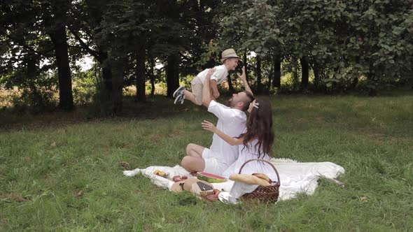 Father and Mother Reaching for Their Male Child