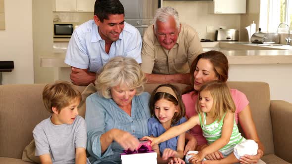 Grandmother Getting Presents from Her Grandchildren on Couch