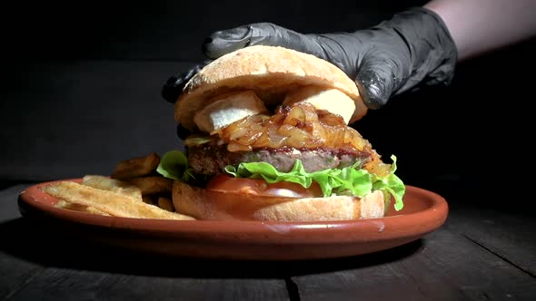 Close Up of an Unrecognizable Chef Finishing Up a Premium Quality Beef Burger with Goat Cheese and